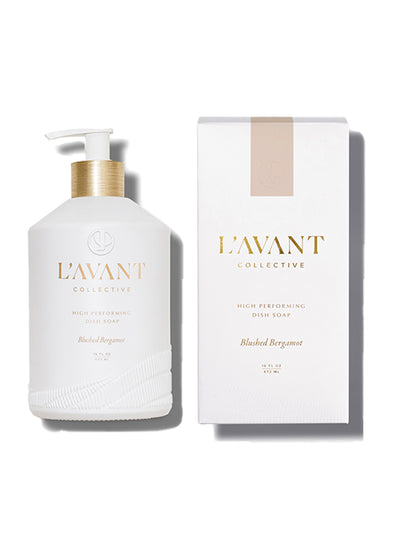 White custom glass bottle for 16 oz dish soap. bottle has white pump with gold neck and gold foil print. to the right, white box with pink stripe at top and gold foil print for L'AVANT Collective dish soap in Blush Bergamot scent.