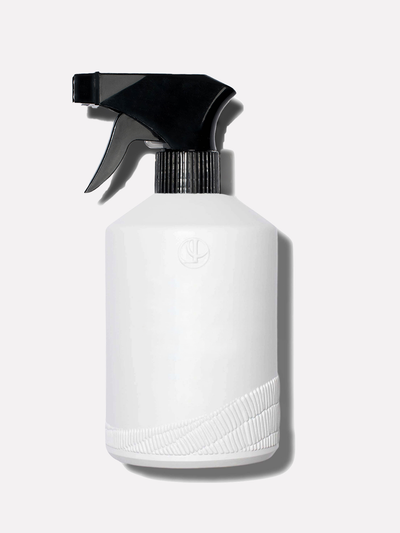 White glass custom bottle with a black sprayer top