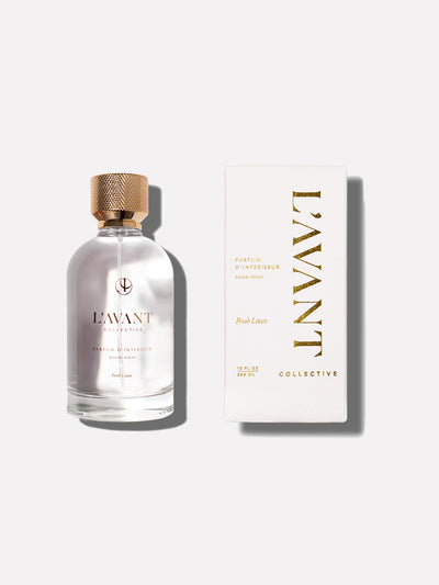 Clear glass bottle with L'AVANT logo stamped in gold foil. White retail box with L'AVANT Collective brand stamped in gold foil.
