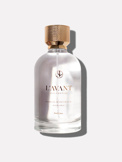 Clear glass bottle with gold foil L'AVANT Collective logo, text Room spray in Fresh Linen fragrance with Gold Cap.
