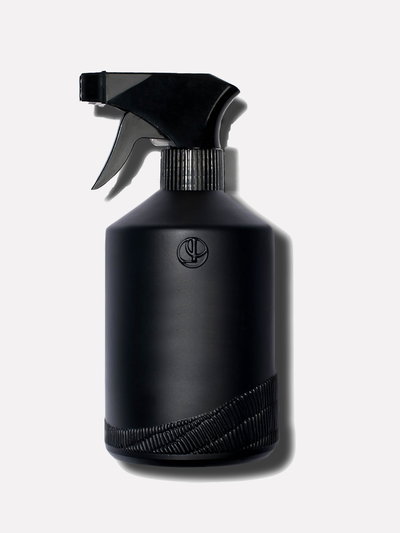 Black glass custom bottle with a black sprayer top.