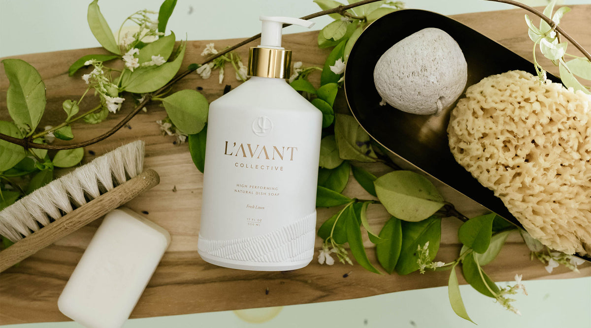 High performance hand soap in the Fresh Linen scent is pictured in a bath scene with some greenery to connect to the plant based nature of the product.