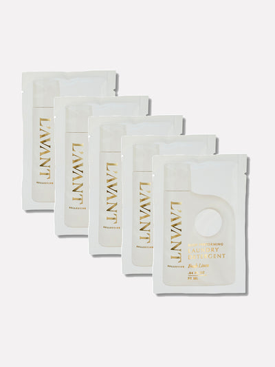 Travel Pouch Set in the Fresh Linen scent. The packaging of 5 units features an elegant, minimalist design with soft cream tones and gold foil lettering. TThe luxurious aesthetic reflects the brand's commitment to high-quality, eco-friendly, and stylish home care essential