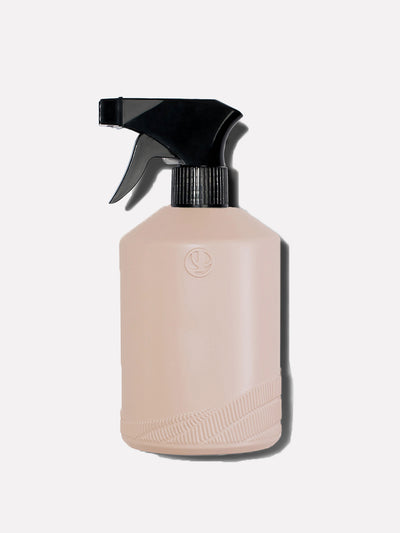Blush pink spray bottle with black top