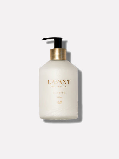 Hand Lotion. 10 oz glass bottle on grey background. Black pump and gold neck.